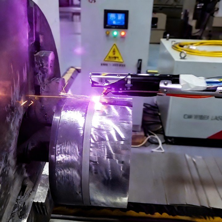 Internal bore laser cladding in action with metallic powder deposition and visible sparks