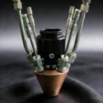 Quad-coaxial powder nozzle for four-channel laser cladding and powder delivery systems